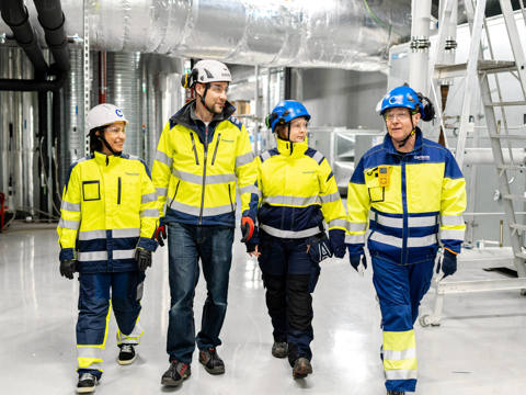 Two technicians pictured in a technical room