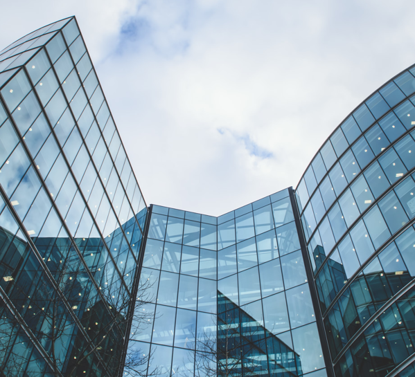 Glass walled building pictured against grey sky