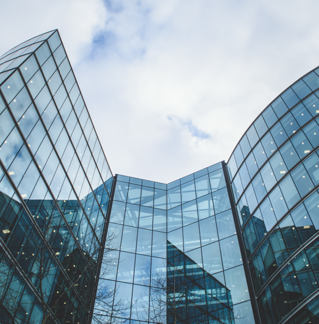 Buildings pictured from the ground, greay sky behind them