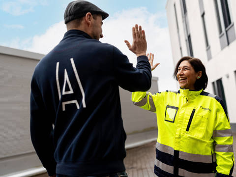 Two people giving a high five to each other