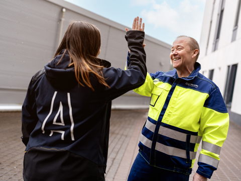Two employees giving each other a high five